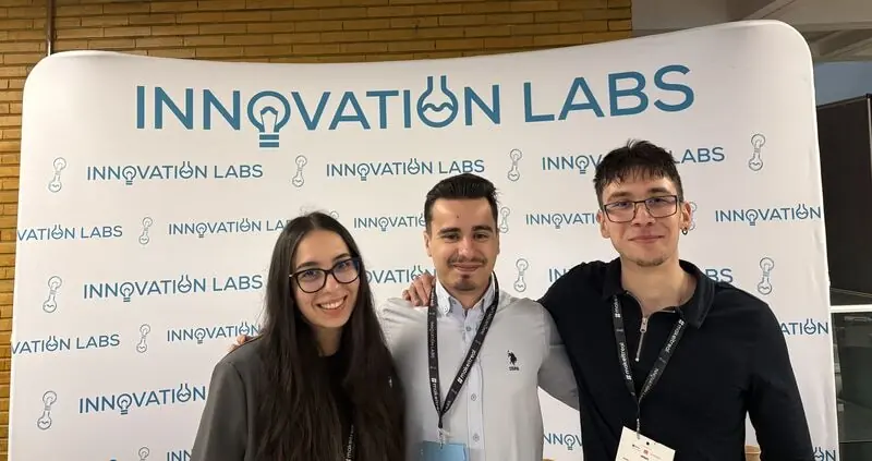 Three members of the Unicorn IT Services team in front of the Innovation Labs backdrop